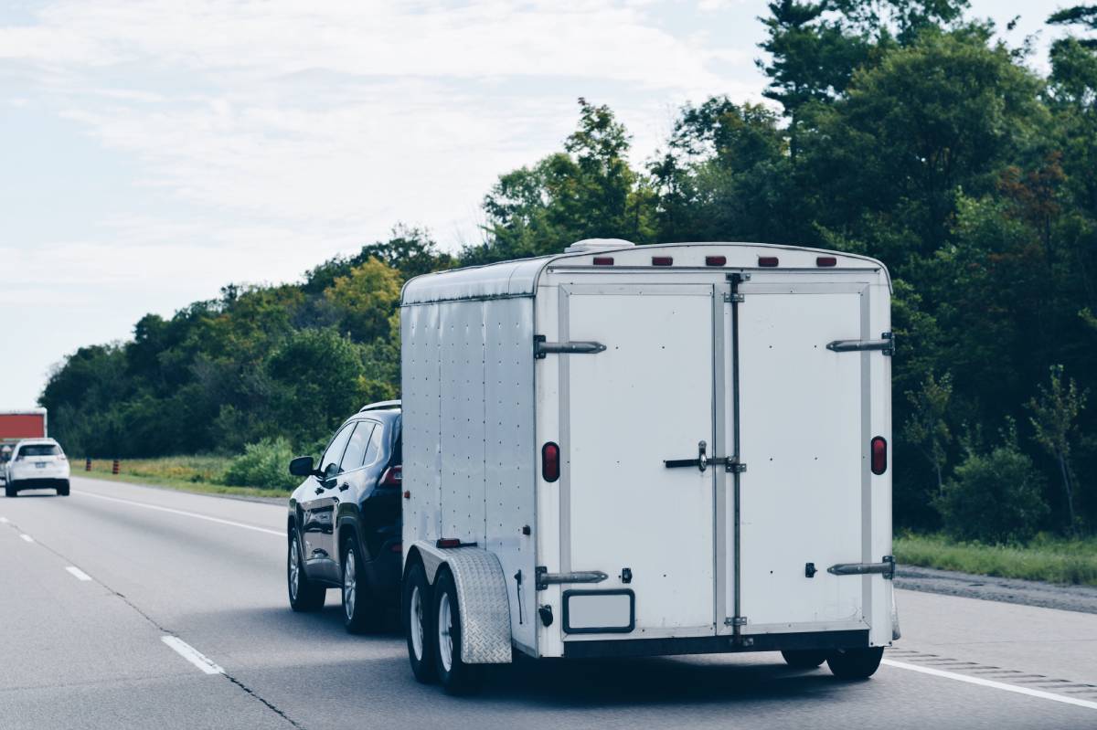 trailer-attached-to-a-car-driving-on-a-highway-ca-2026-03-24-08-39-08-utc