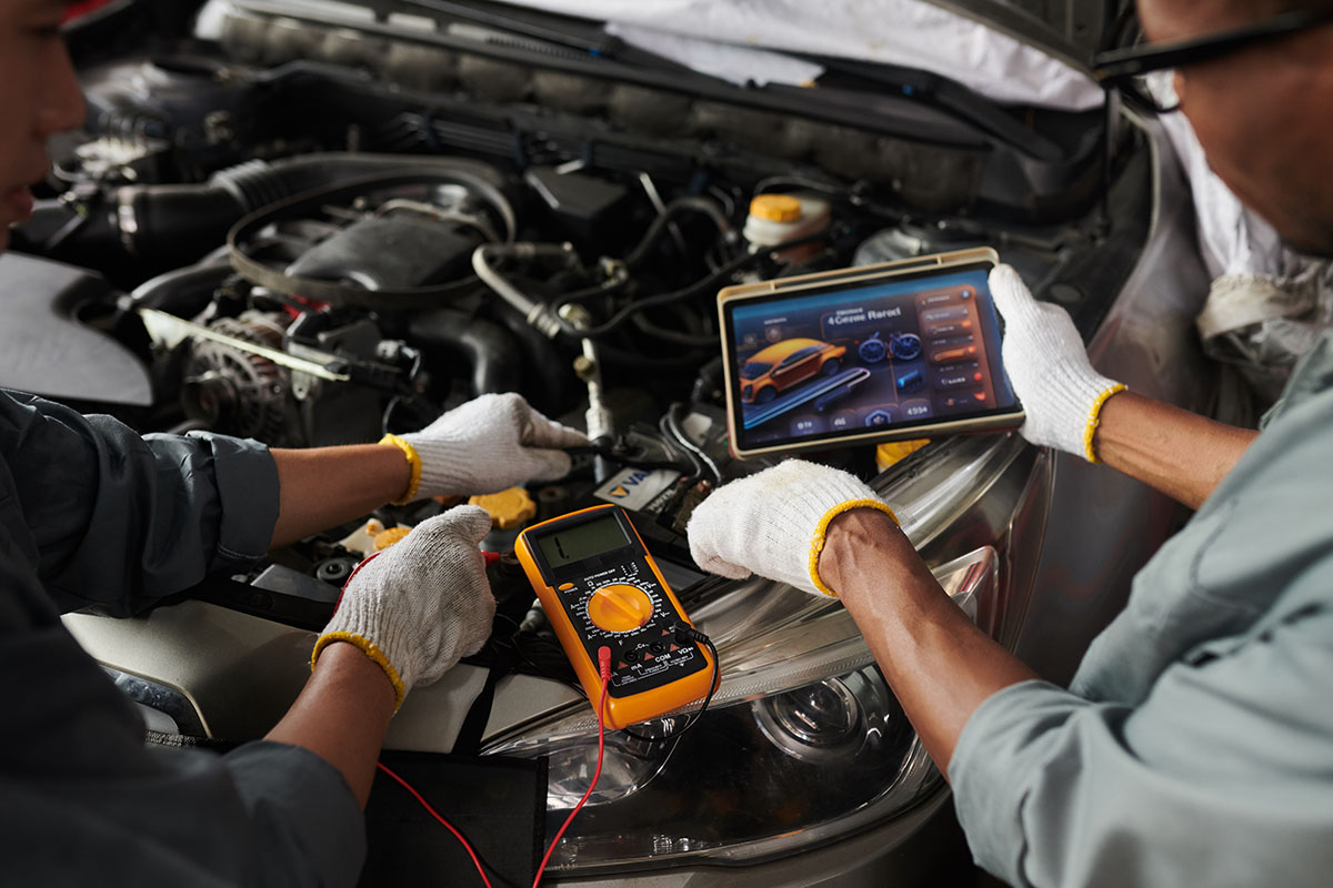 auto-mechanics-inspecting-car-with-digital-technol-2026-01-07-07-10-05-utc